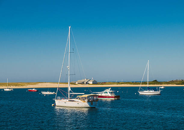 Sailboats and motor launches are moored off Hyannisport. Massachusetts on a late September afternoon.