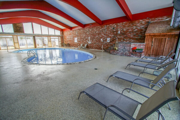 Photo of swimming pool with lounging chairs