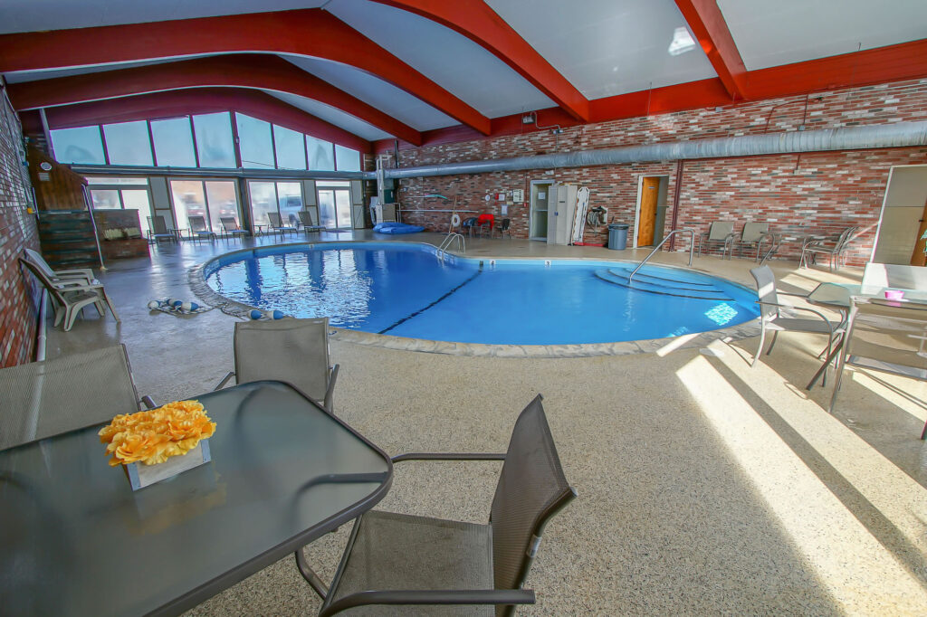Photo of swimming pool, tables and chairs